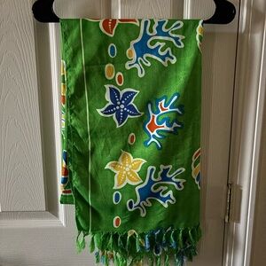 Swim wrap in colorful fish print.  Approx 70x42
